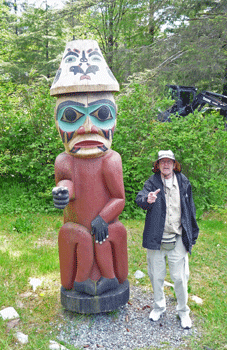 Walter Cooke and totem at Saxman totem park Ketchikan
