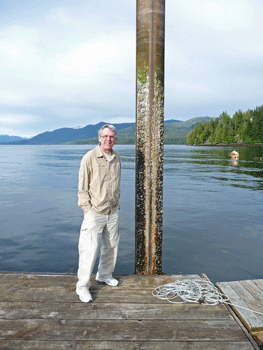 Walter Cooke next to dock pole at low tide Clover Pass