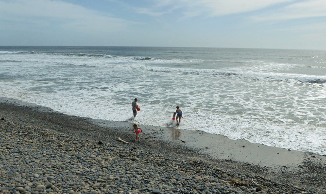 Family playing in ocean
