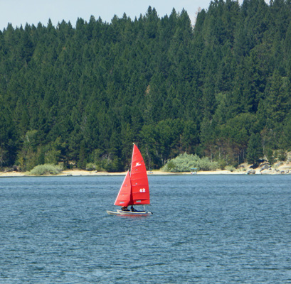 Red sailed sailboat