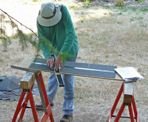 Walter trimming shingles for roof of gazebo