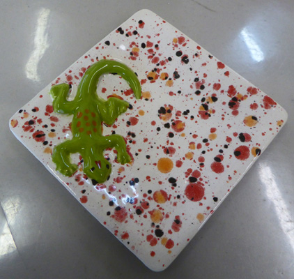 A gecko on a jewelry dish.