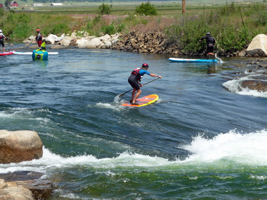 Stand up boarder across top of falls