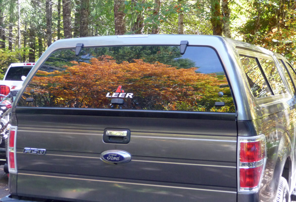 Fall color reflected in truck window Toketee Falls OR