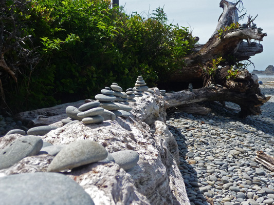 Rock cairns on log at Ruby Beach